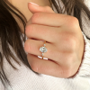 1.50 Ct Oval Moissanite & .12 Ctw Marquise Diamond Three Stone Engagement Ring
